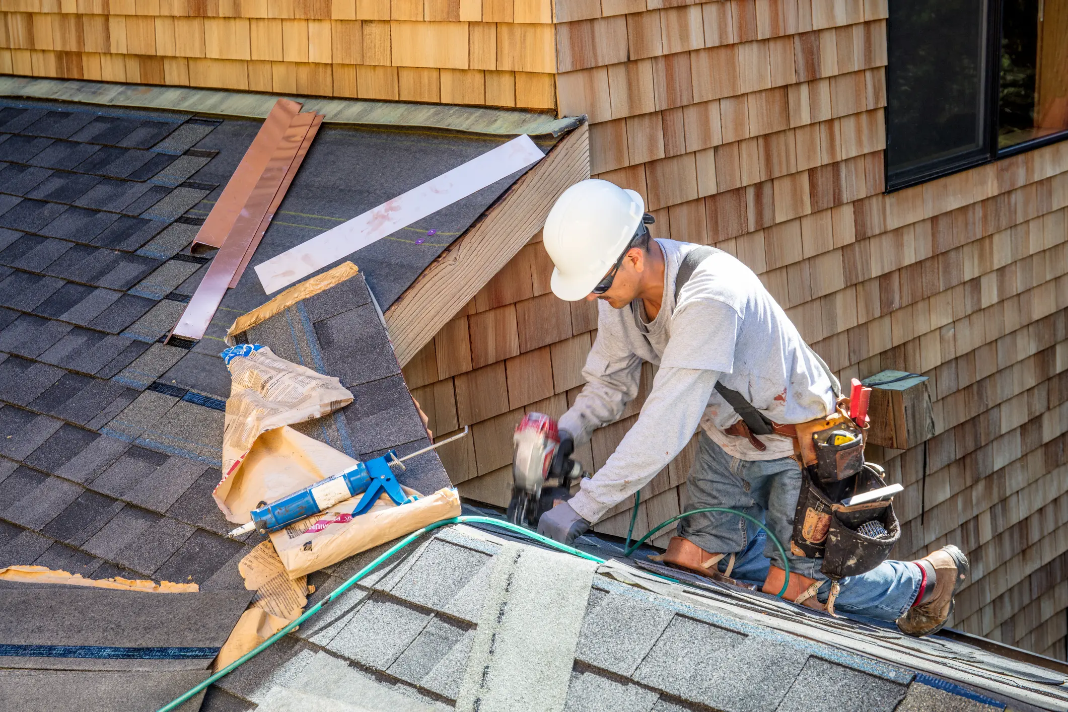 Professional roofer completing asphalt shingle roofing installation on a Brush Prairie home.