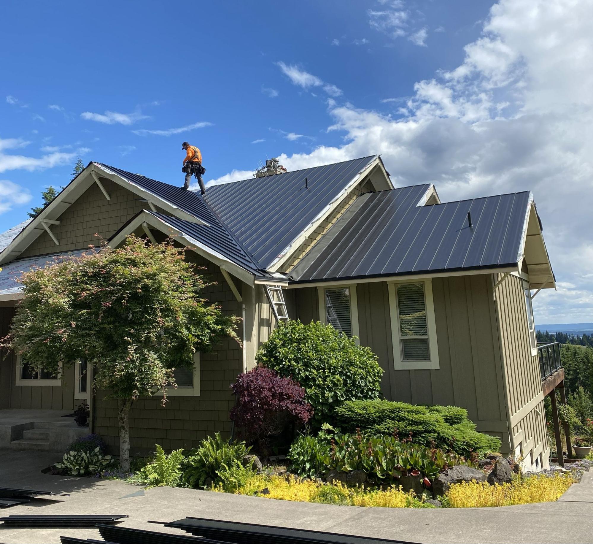 Alfred's Roofing inspector evaluating a metal roof on a Southwest Washington home.