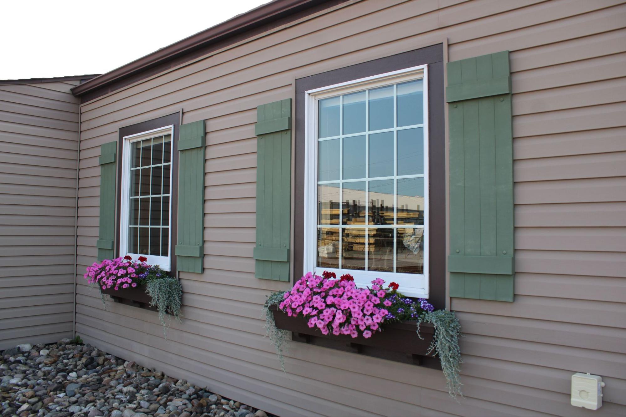Lap siding installation on a Vancouver, WA home with green shutters and flower boxes