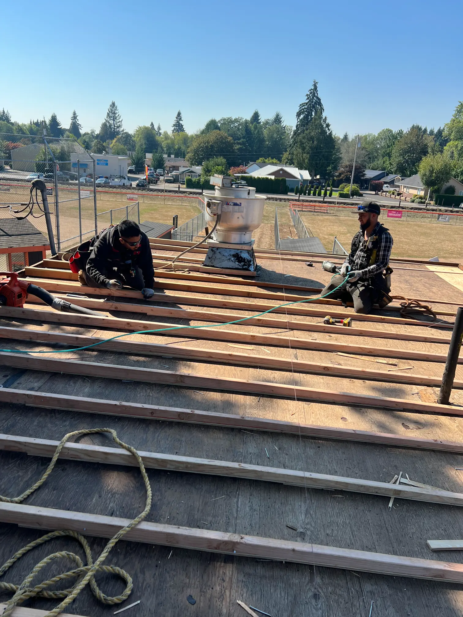 Alfred's Roofing crew preparing a low-slope roof deck for flat roofing in Vancouver, WA