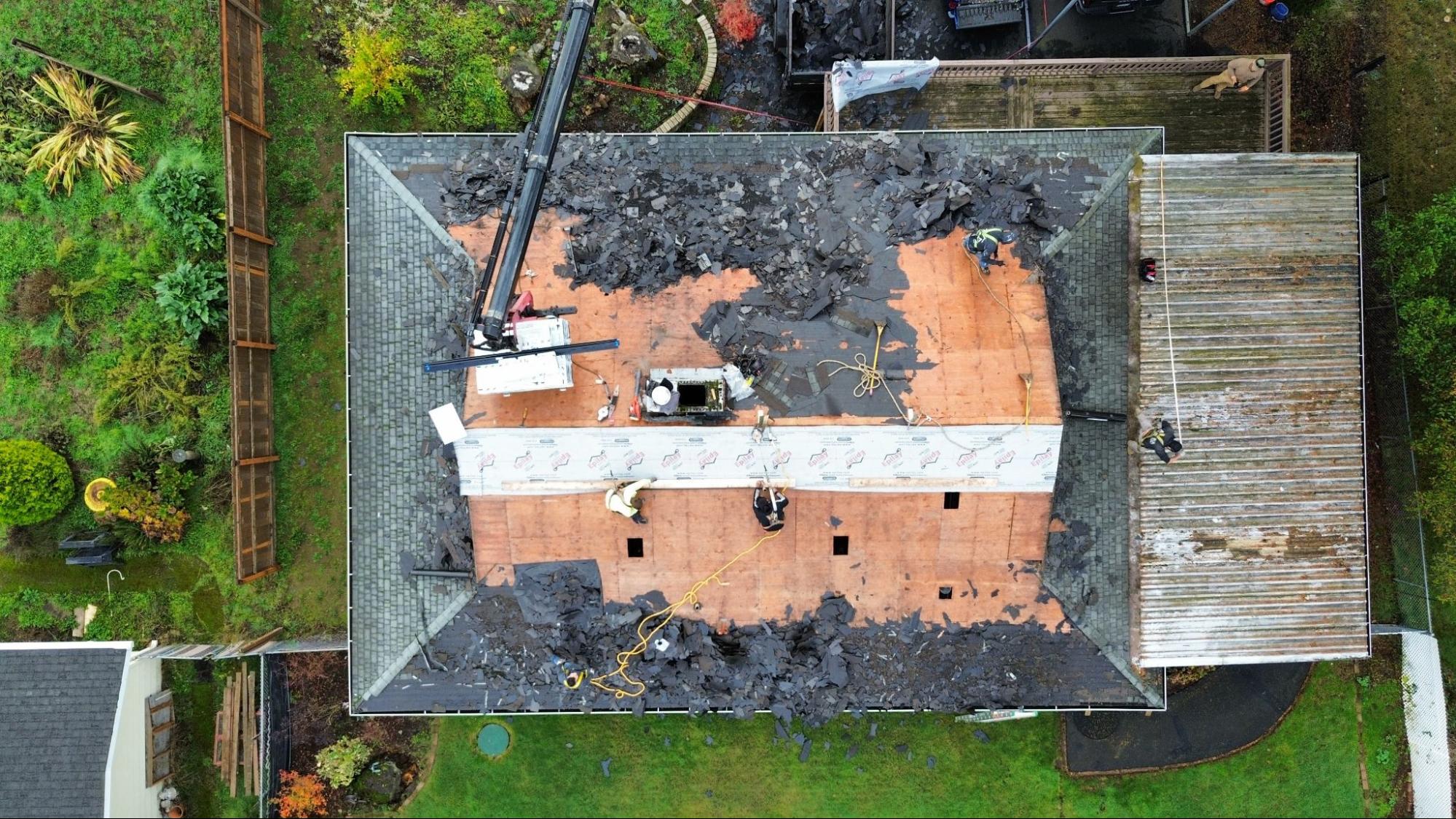 Aerial view of a Southwest Washington home during a full roof replacement with decking exposed.