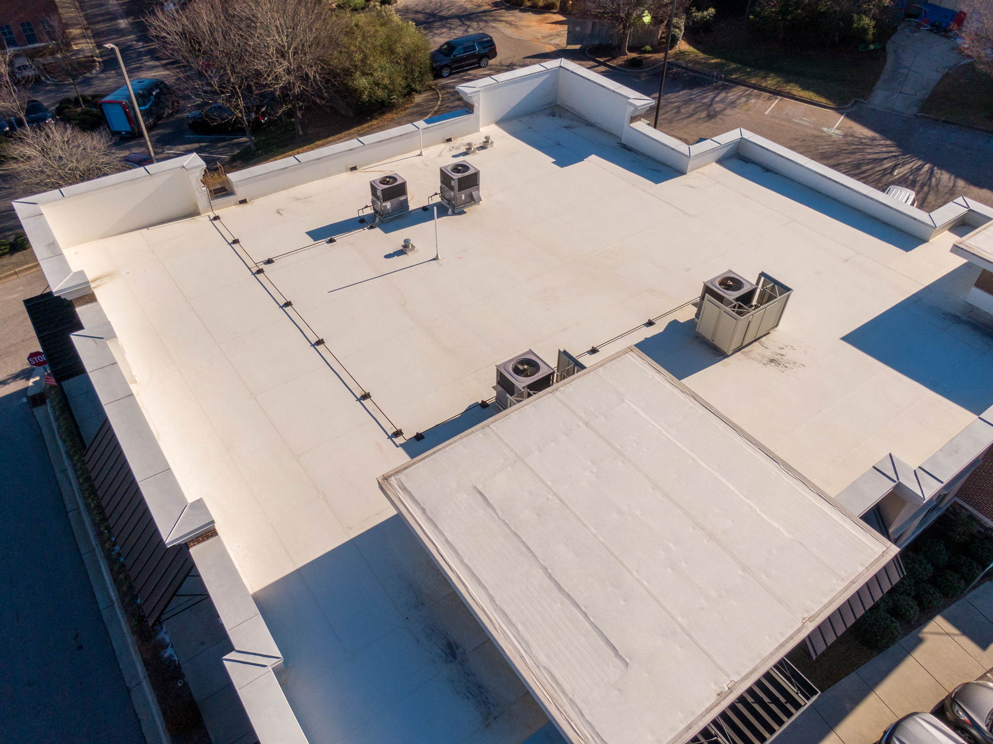 A flat, low-slope commercial roof with rooftop HVAC units, typical of Vancouver, WA buildings