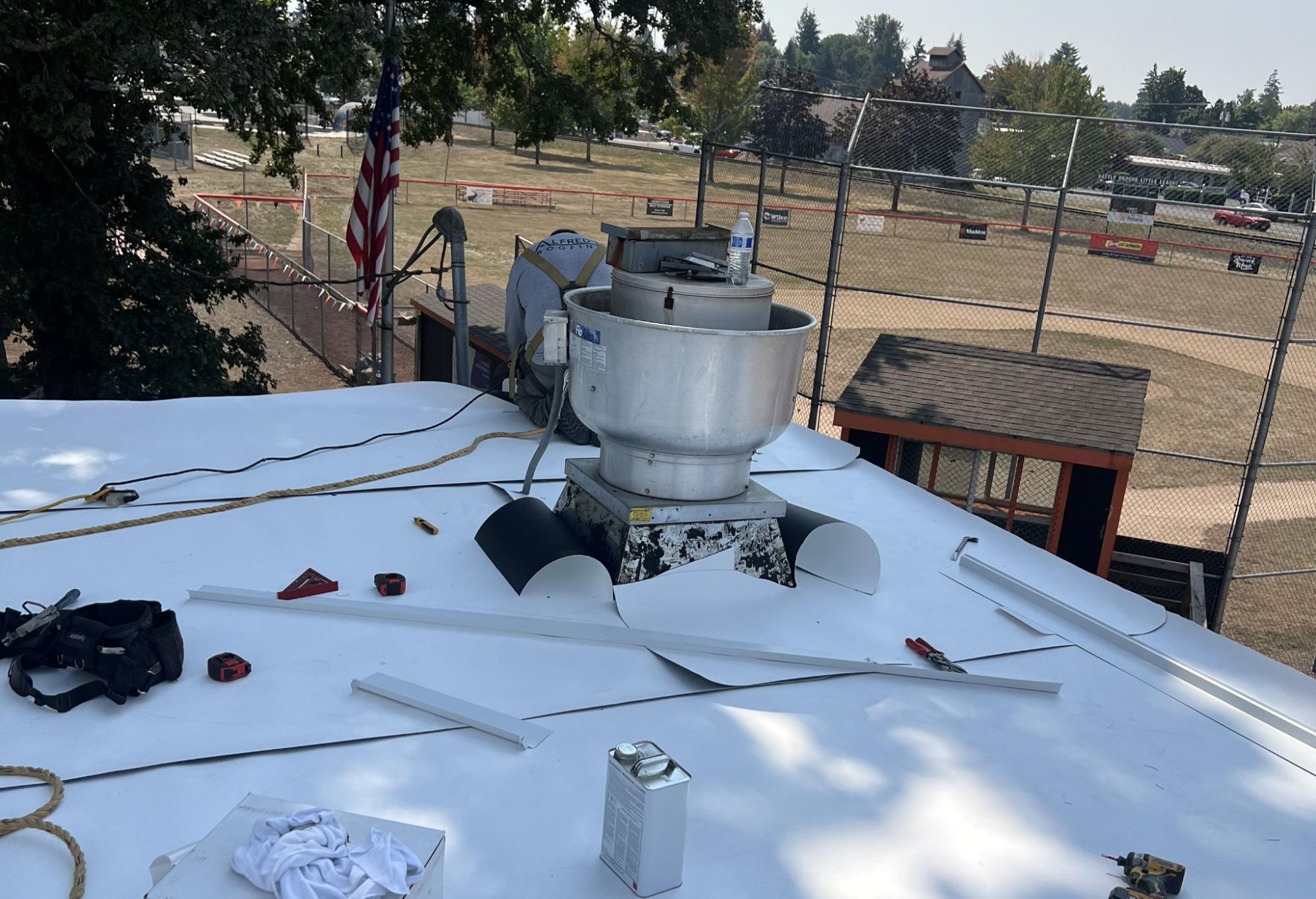 Flat roof membrane and vent flashing during commercial roof replacement in Southwest Washington