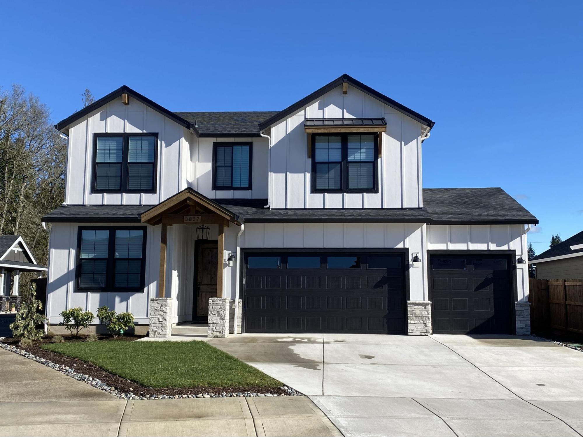 New asphalt shingle roof and board-and-batten siding on a Clark County home by Alfred's Roofing.