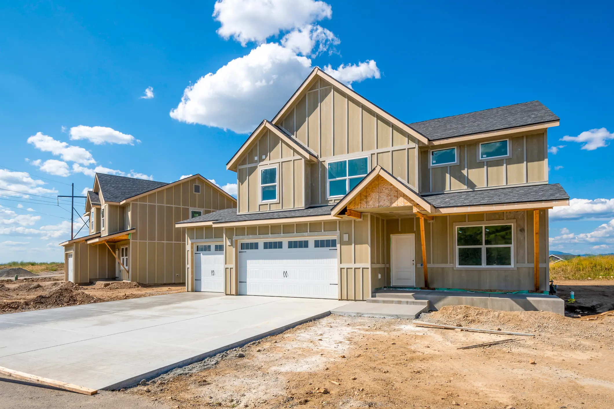 New construction home with a completed architectural shingle roof on a newly built residential lot